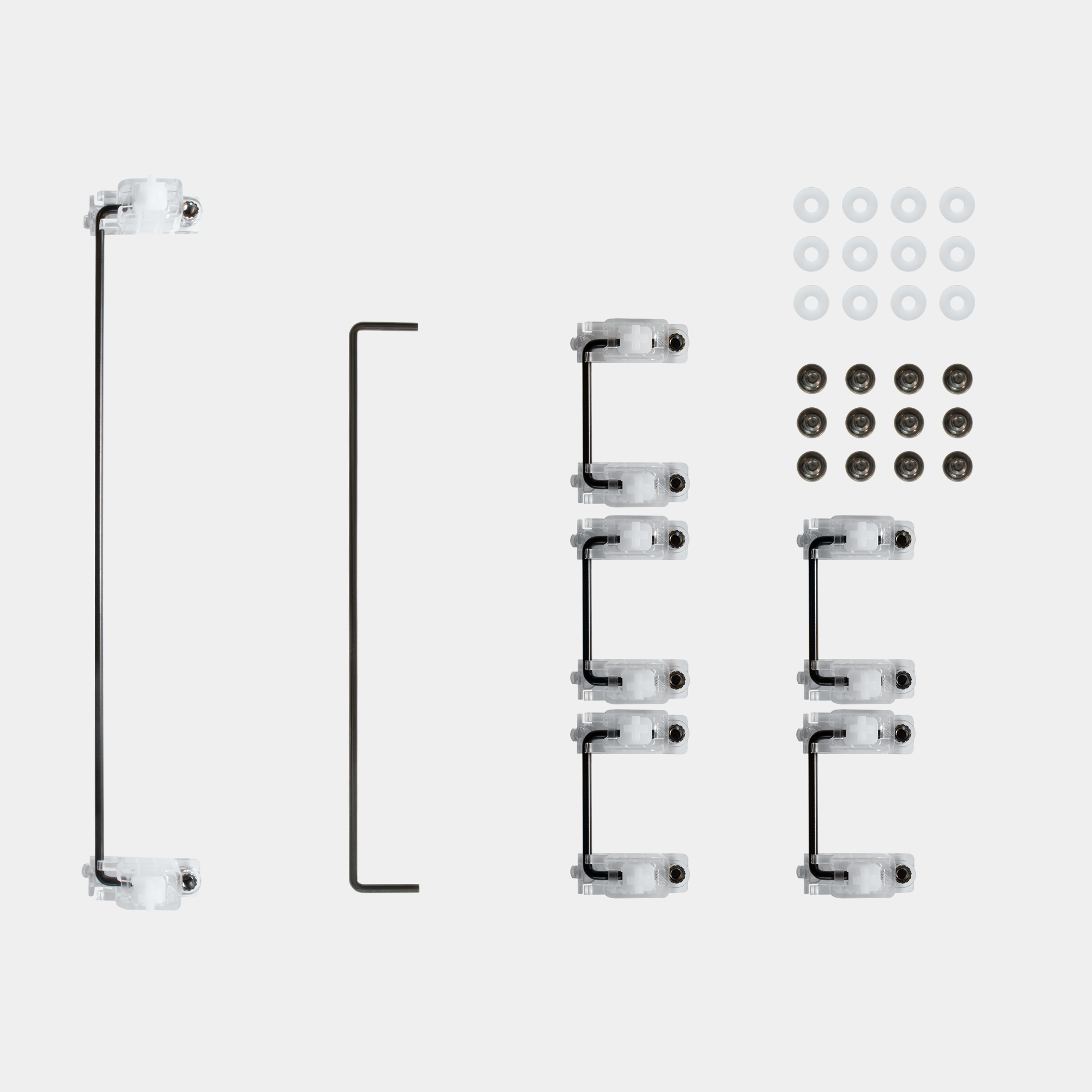 A spread of clear polycarbonate Staebies v2. There is one 7 unit wire, one 6.25 unit wire, five 2 unit wires, 12 screws, 12 washers, and 12 housing + stem pairs.